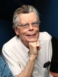 Stephen King all smiling in a headshot picture. 